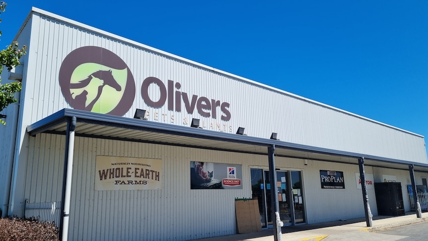 A large corrugated iron warehouse with 'Olivers Pets and Plants' signed on top 