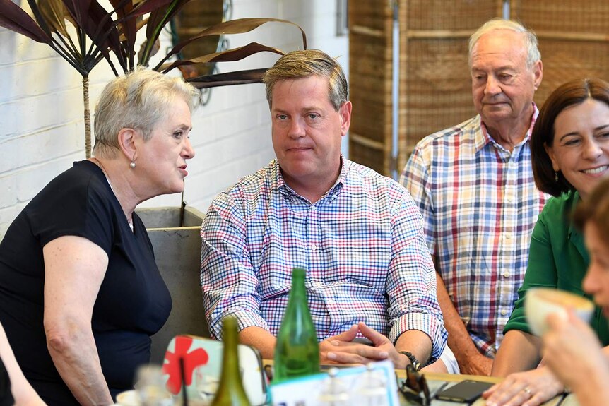 Queensland Opposition Leader Tim Nicholls chats to his mother Barbara as he meets friends and family at a cafe in Brisbane.