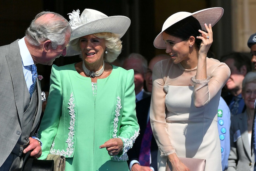 Meghan Markle stands next to Prince Charles and Camilla.