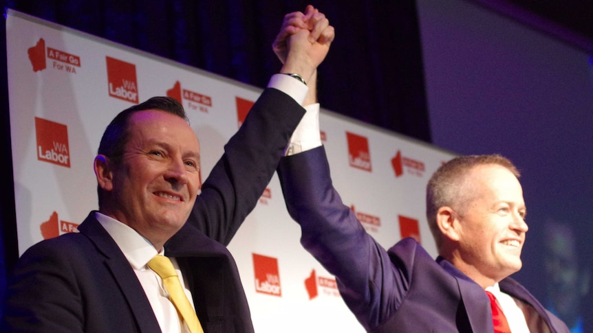 Mark McGowan and Leader Bill Shorten raise their held hands at the WA Labor conference.
