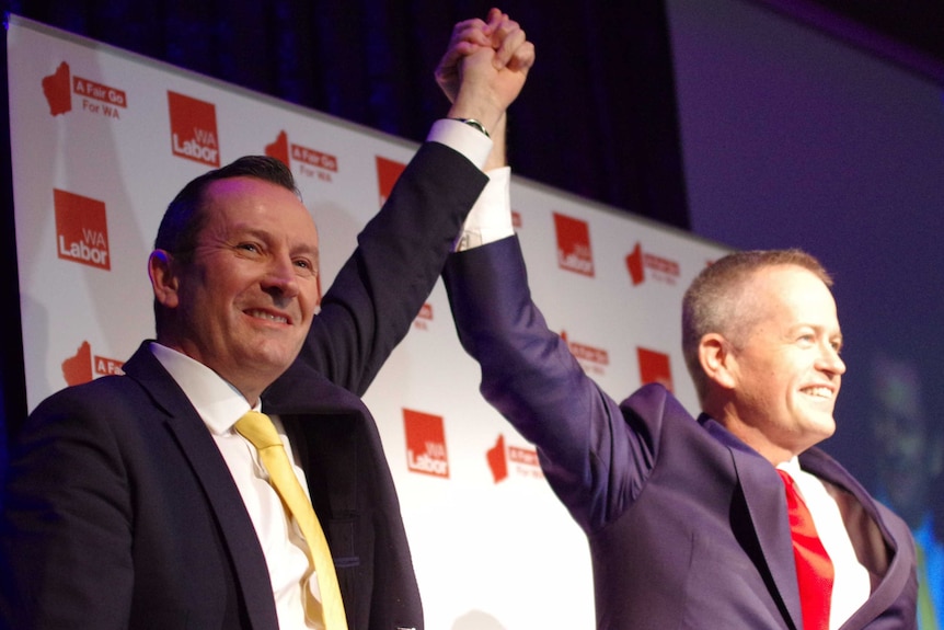 Mark McGowan and Leader Bill Shorten raise their held hands at the WA Labor conference.