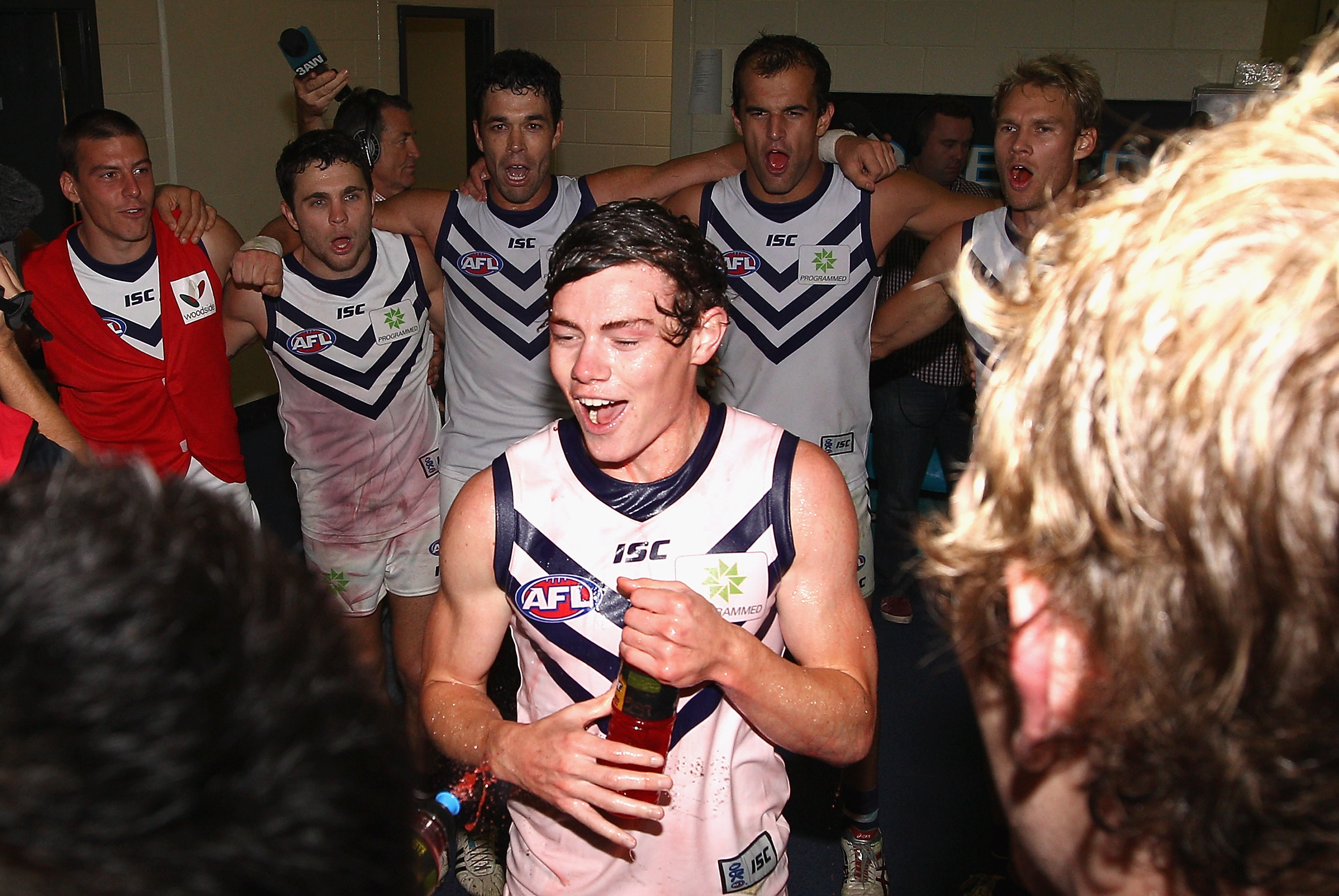 Lachie Neale sings the team song in the middle of circle