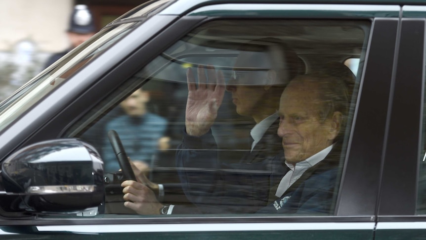 Prince Philip is driven in a car in London