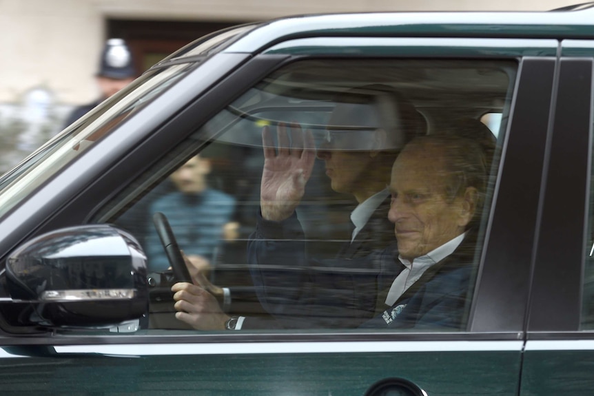 Prince Philip is driven in a car in London