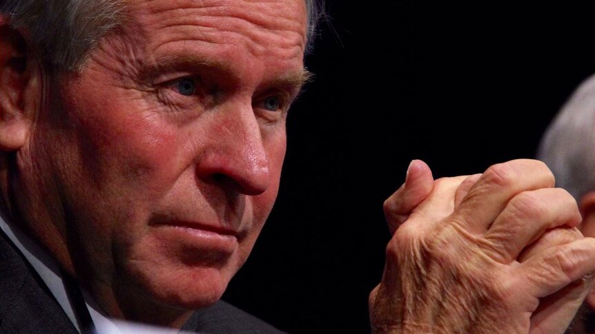 Close-up of WA Premier Colin Barnett with his hands clasped in front of his face
