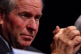 Close-up of WA Premier Colin Barnett with his hands clasped in front of his face