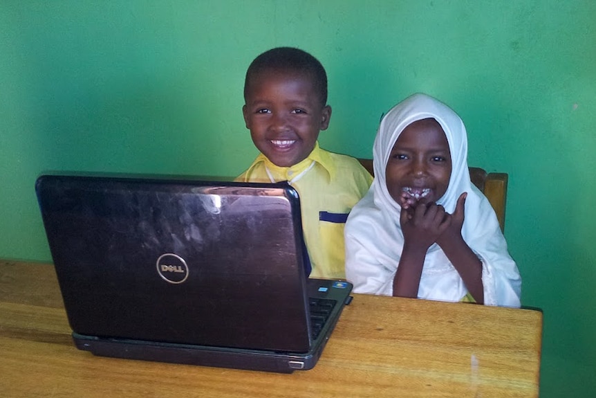 Children in the Misha school with a laptop computer.
