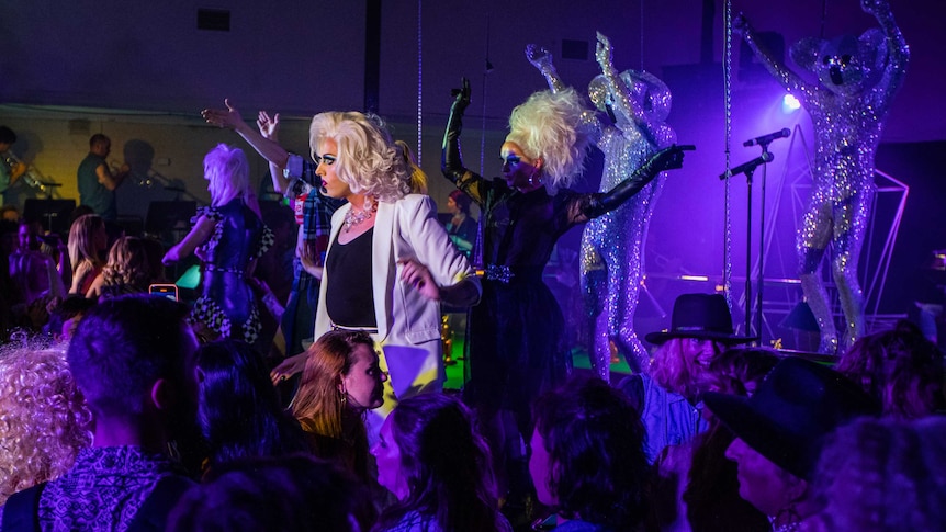 Drag queens and people dressed up as sequinned koalas performing in a crowded night club