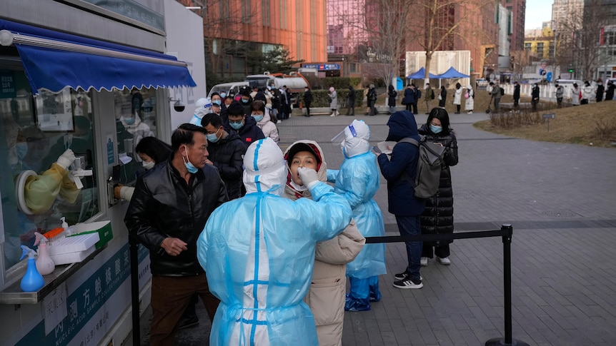 People line up to get a throat swab for the COVID-19 test at a mobile coronavirus testing facility