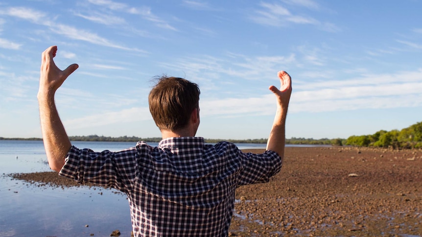 A man holding his arms up like a crab