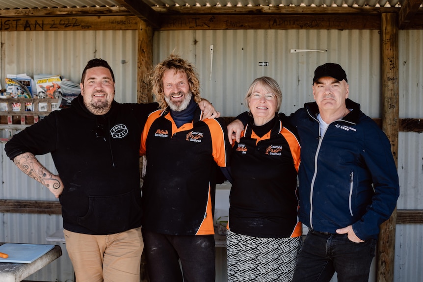 Chefs Mark Best and Duncan Welgemoed stand in matching black shirts with Tracy and Glen Hill from Coorong Wild Seafood. 