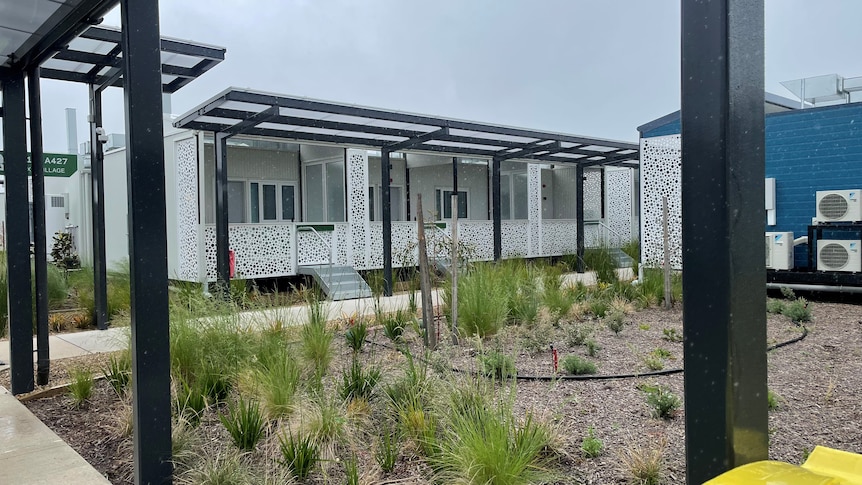 A standalone unit with a decorated facade, a veranda and a small garden area.