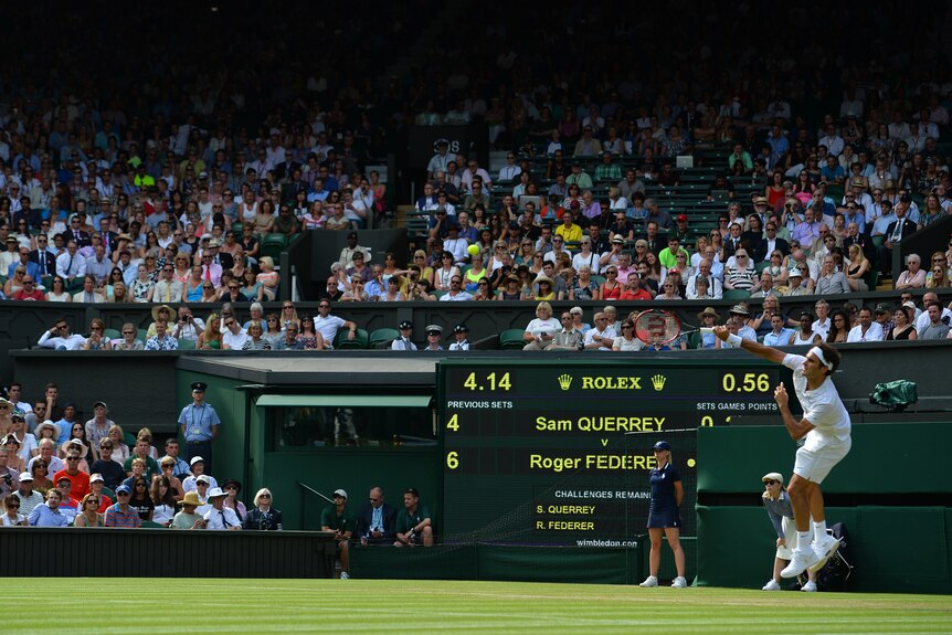 Federer serves at Wimbledon