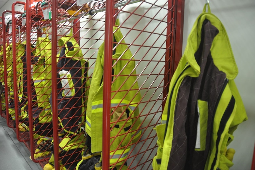 High-vis jackets hang in a row