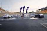 An electric and petrol-powered car lined up on the starting line.