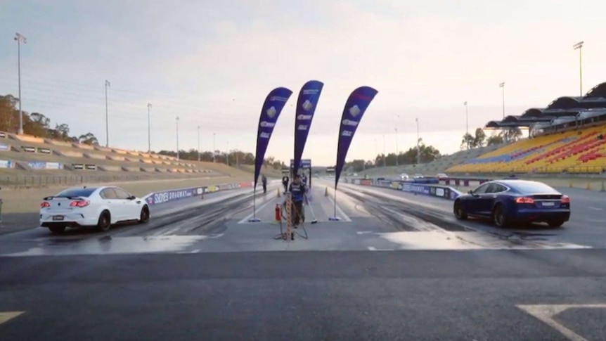 An electric and petrol-powered car lined up on the starting line.