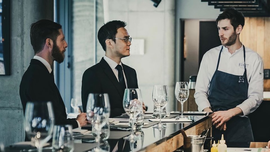 Picture of three men in a restaurant