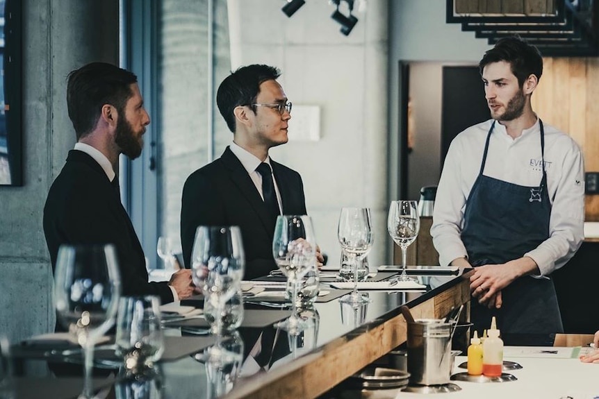 Picture of three men in a restaurant