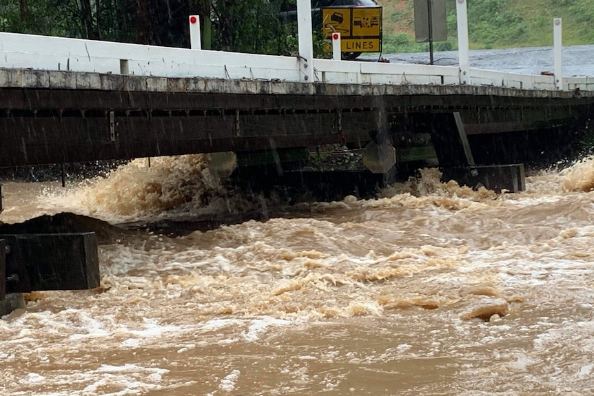 Flood water gushed underneath a bridge