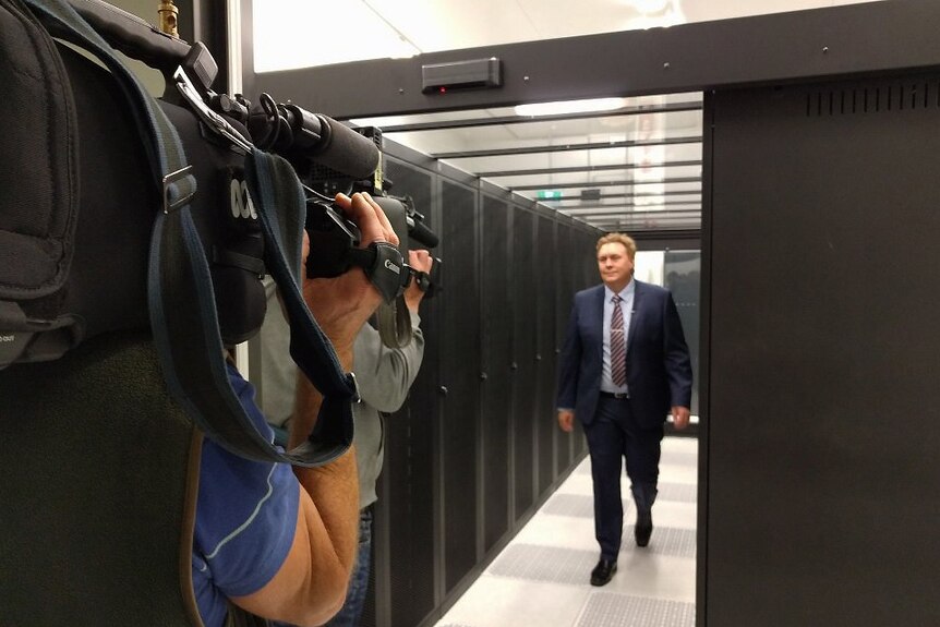 Businessman Scott Hicks walks through the new data centre