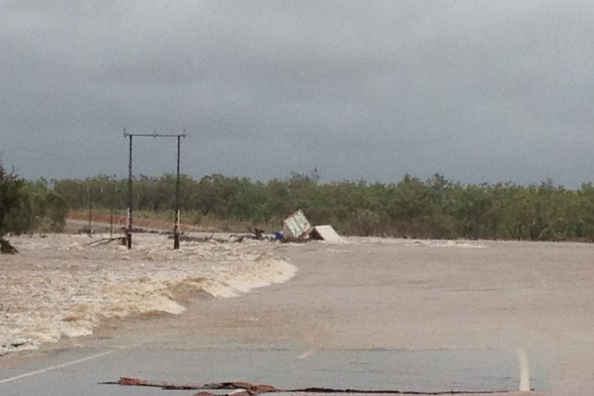 Two men trapped as floodwater derail freight train