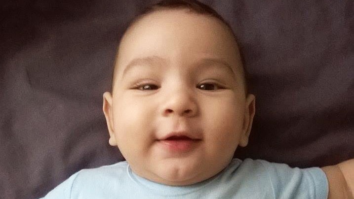 Smiling baby Samuel who may be sent to Nauru