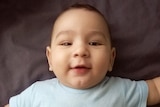 Smiling baby Samuel who may be sent to Nauru
