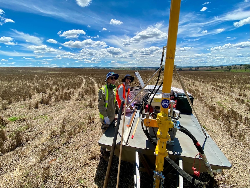 Two people drilling soil samples