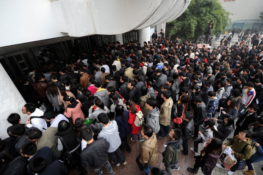 People walk into the hall of an exam centre during China's annual National Public Servant Examination