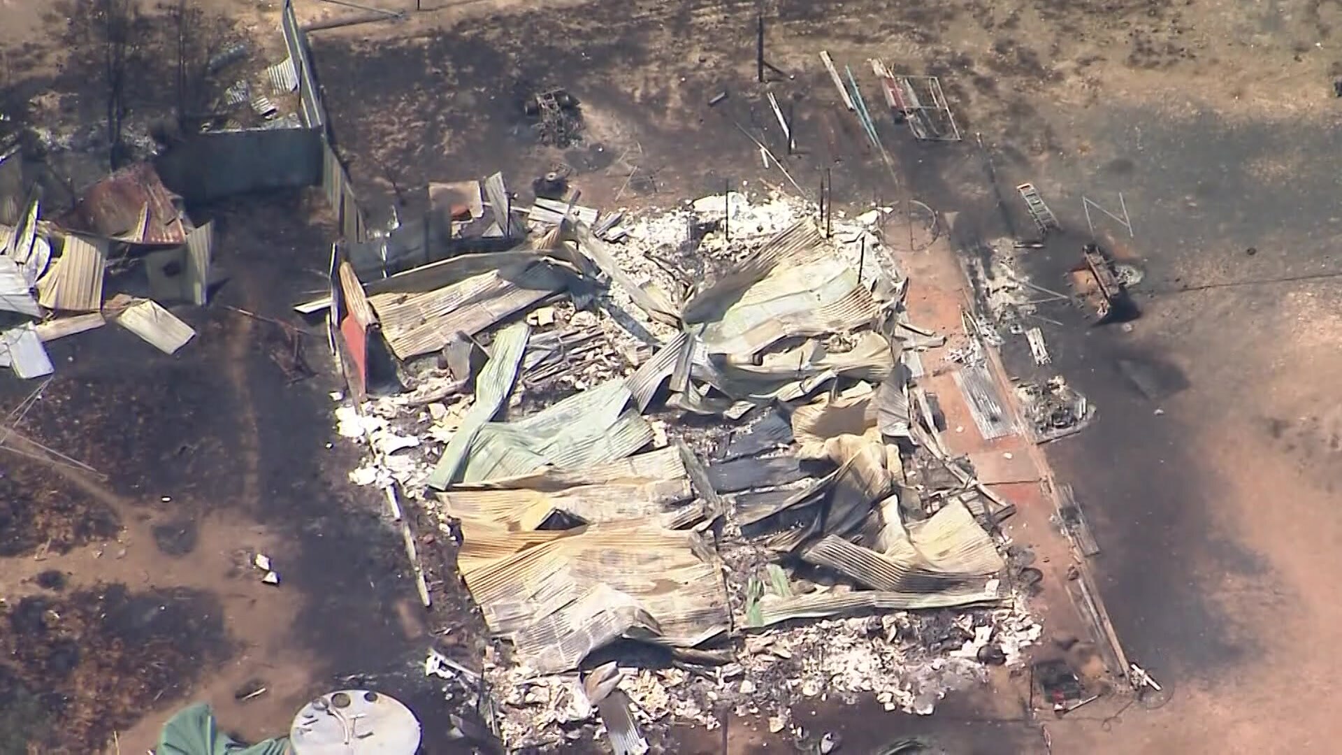 a flattened burnt-out building photographed from a helicopter