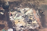 a flattened burnt-out building photographed from a helicopter