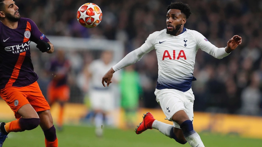 Danny Rose looks at the ball as it bounces at head height with his arms stretched out as Riyad Mahrez runs towards him