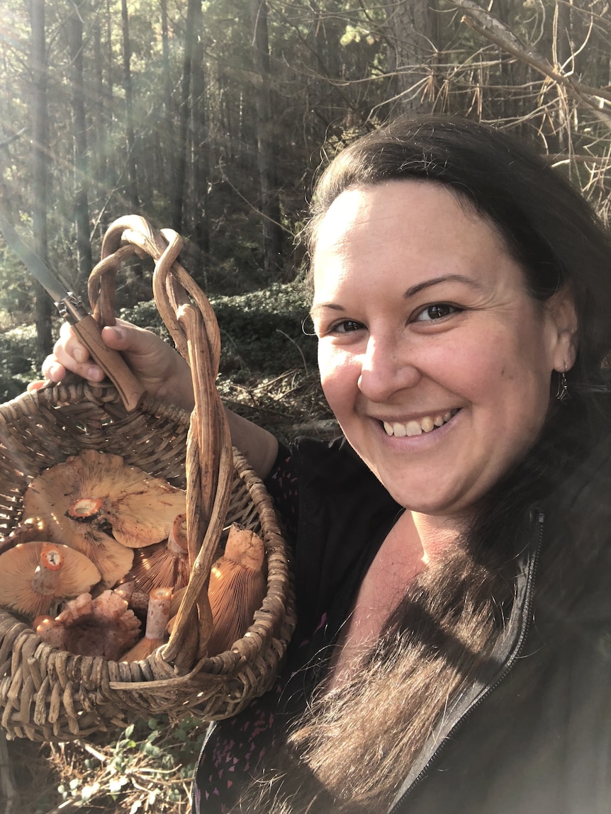 A woman foraging for mushrooms in Melbourne, to supplement what she grows in her garden.