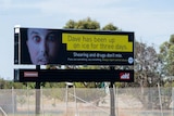 A billboard ad beside a road in Horsham, picturing the gaunt face of a man beside the words "Shearing and drugs don't mix"