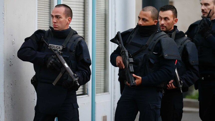 French police secure the area as shots are exchanged in Saint-Denis, France