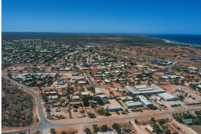 An aerial shot of a town site on the coast