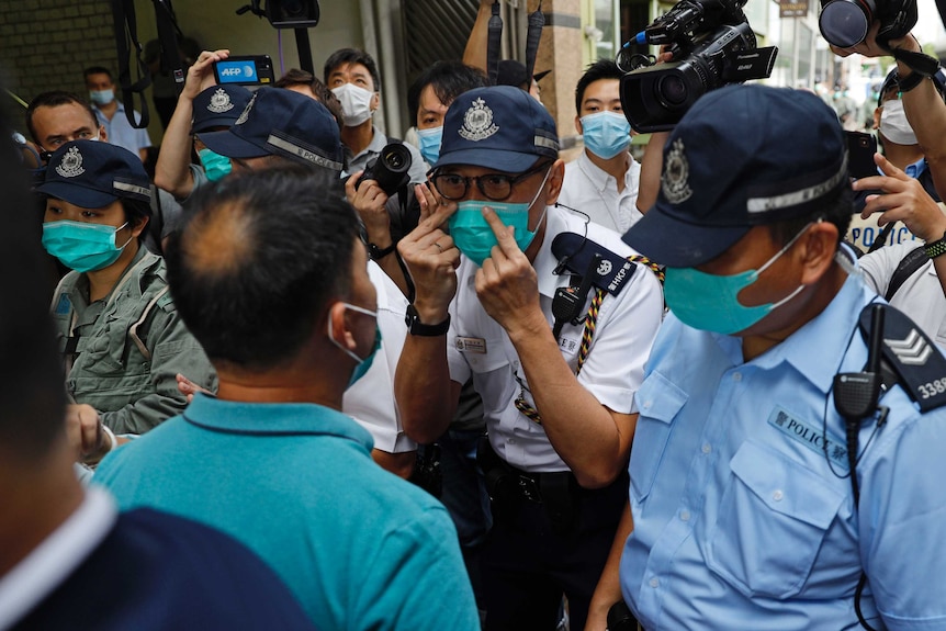 A police officer gestures to a protester