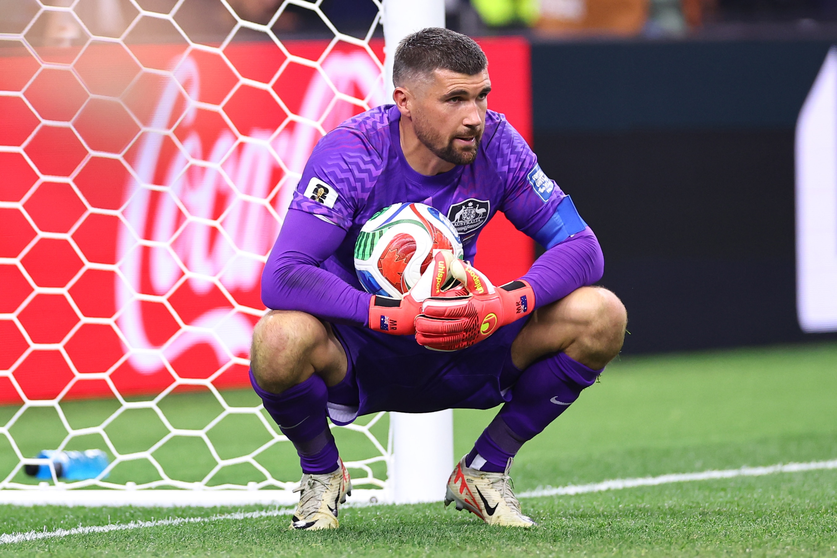 Mat Ryan crouched in front of his goal