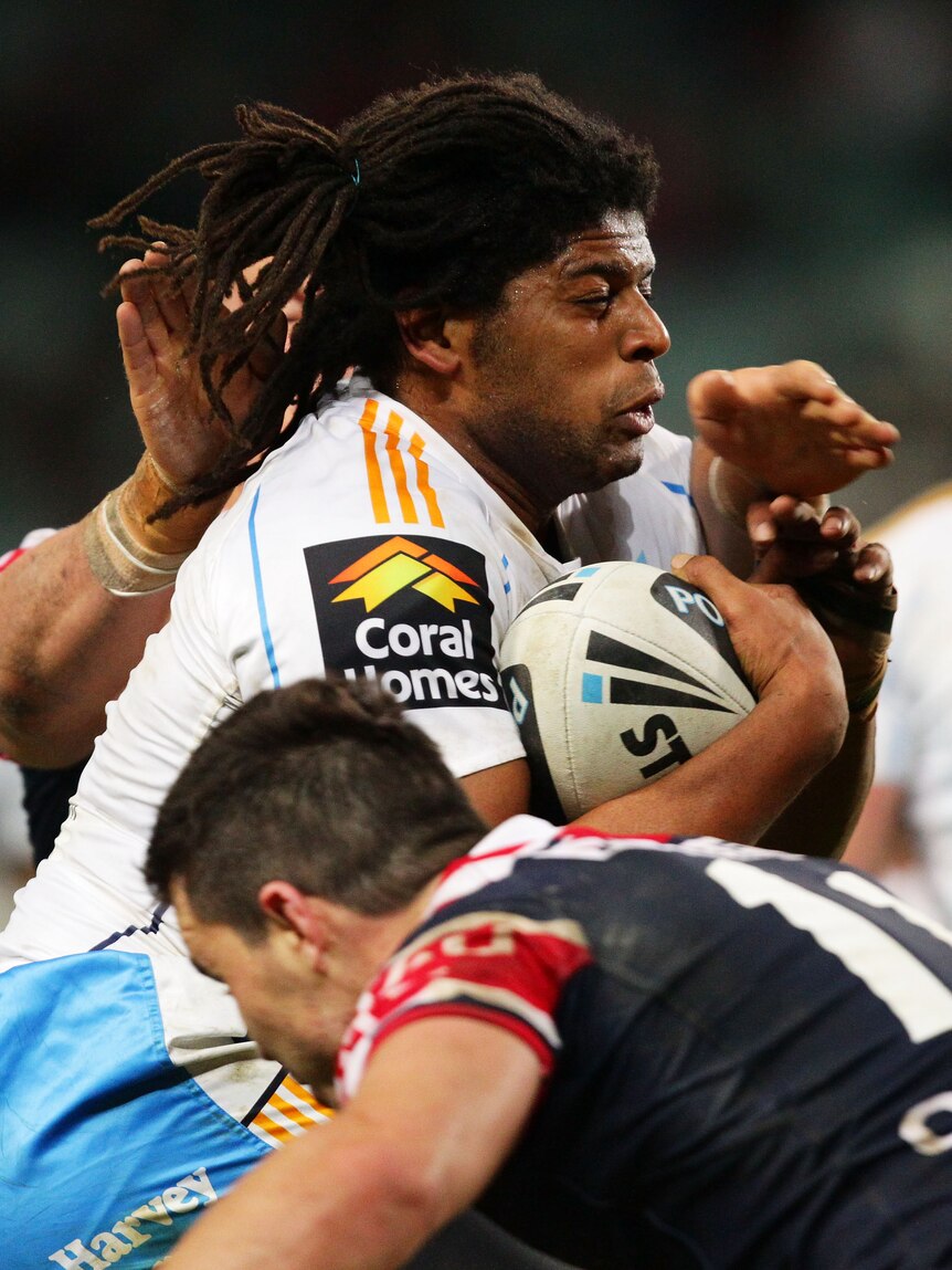 Heavy hit ... Jamal Idris takes on the Roosters defence