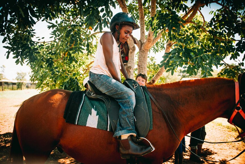 Student Jahlee Sambo sitting in a horse.