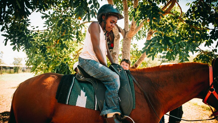 Student Jahlee Sambo sitting in a horse.