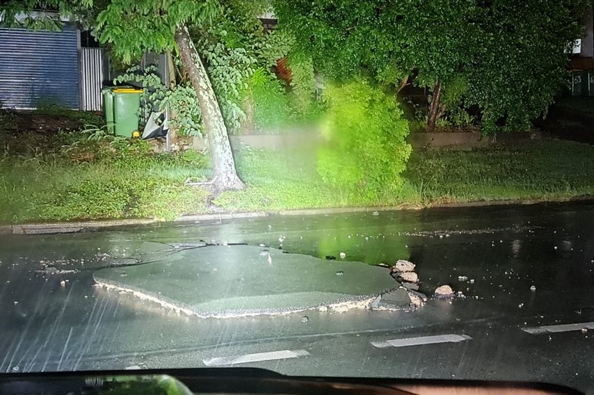 Bitumen washed away on a road at Alexandra Hills.