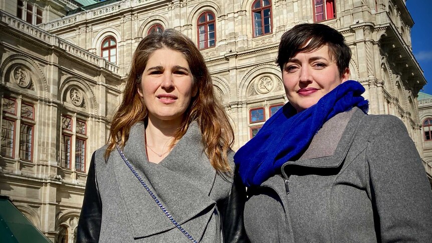 Australian opera singers Nicole Car and Margaret Plummer stand outside Vienna's state opera house.