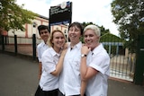 Newtown high school students in uniform share a laugh outside the school in Newtown.
