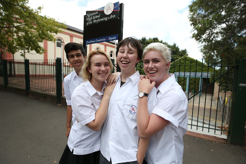 Newtown high school students in uniform share a laugh outside the school in Newtown.