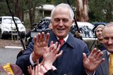Malcolm Turnbull high fives school children in Victoria.