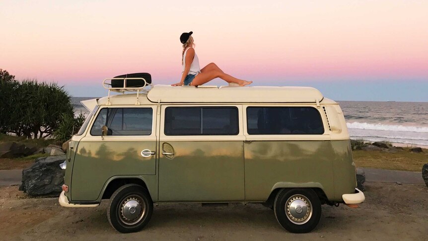 Emma Carey sits on the roof of a kombi van.