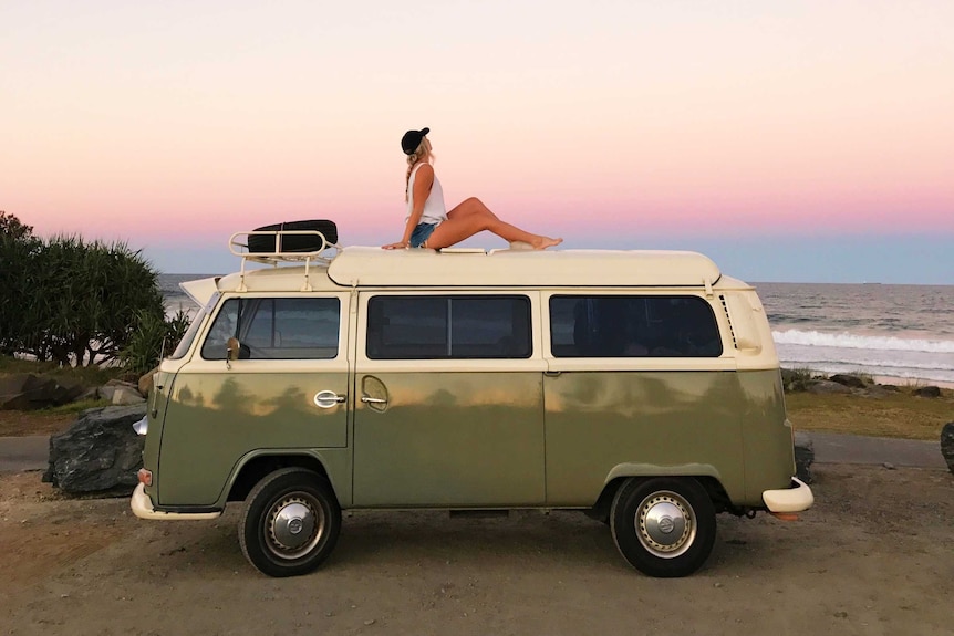 Emma Carey sits on the roof of a kombi van.