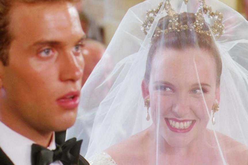 Toni Collette as Muriel Heslop stares excitedly at her husband on her wedding day.