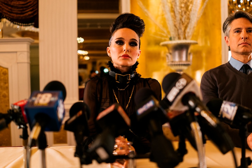 Colour still of Natalie Portman at a press conference in 2018 film Vox Lux.